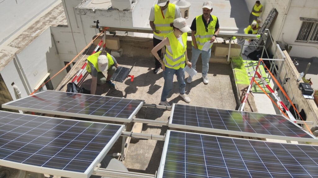 Researchers collaborating on photovoltaic testing at a living laboratory in Malta.